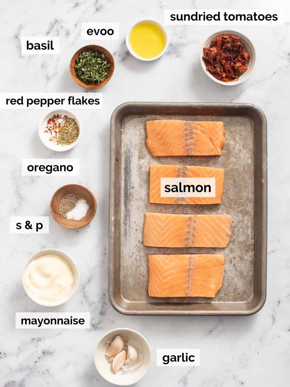 Mediterranean salmon ingredients on a white marble background.
