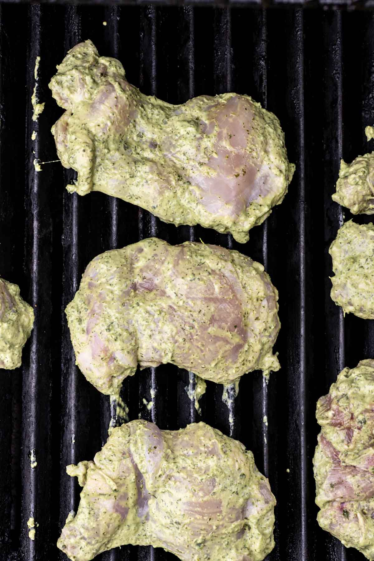 Boneless chicken thighs in herb marinade on the grill