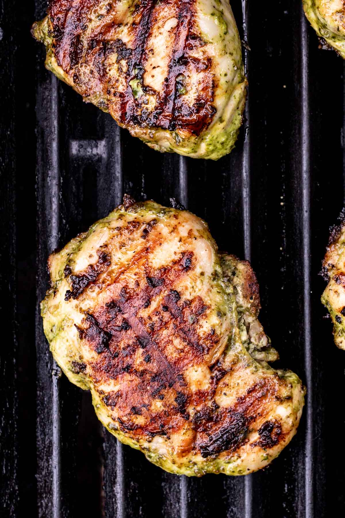 Boneless chicken thighs after grilling on one side.