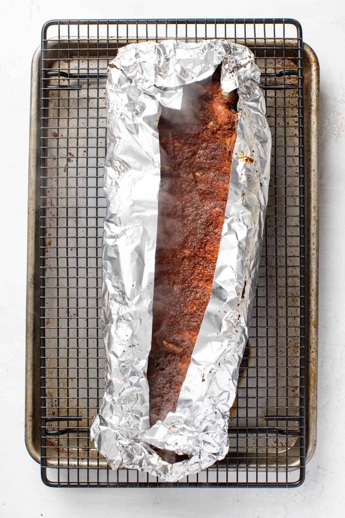 Uncovering the tin foil from the baked ribs.