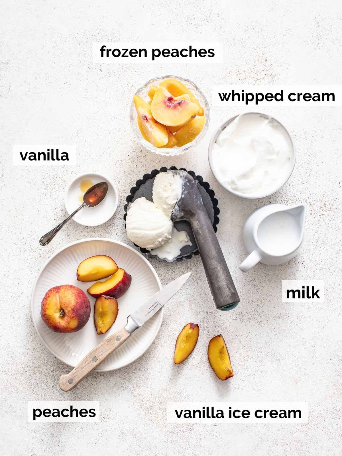 Ingredients for peach milkshakes on a white background.