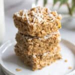 Zucchini bars topped with oats and a white cream cheese drizzle.