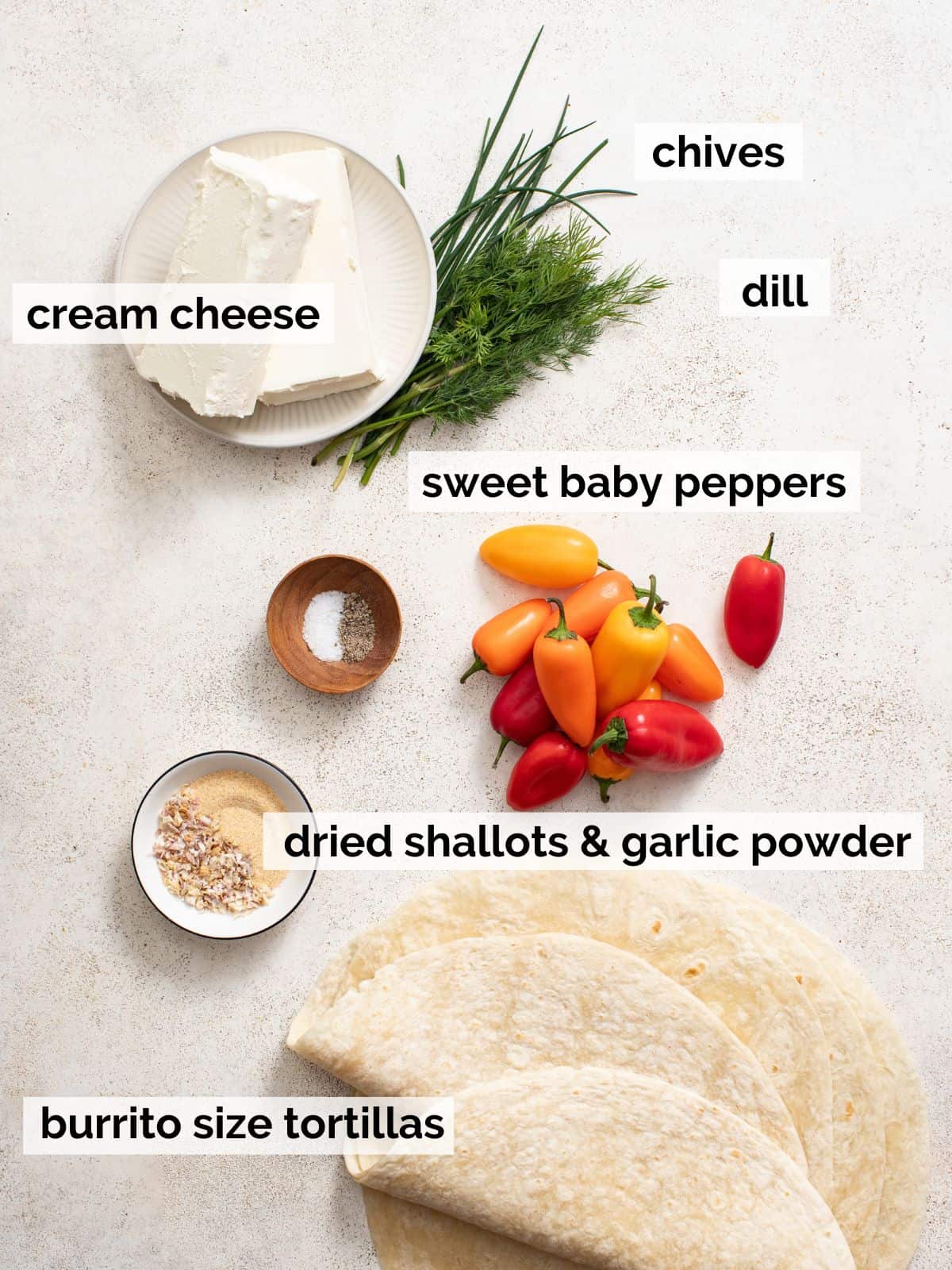 Ingredients for cream cheese tortilla roll ups on a white background.