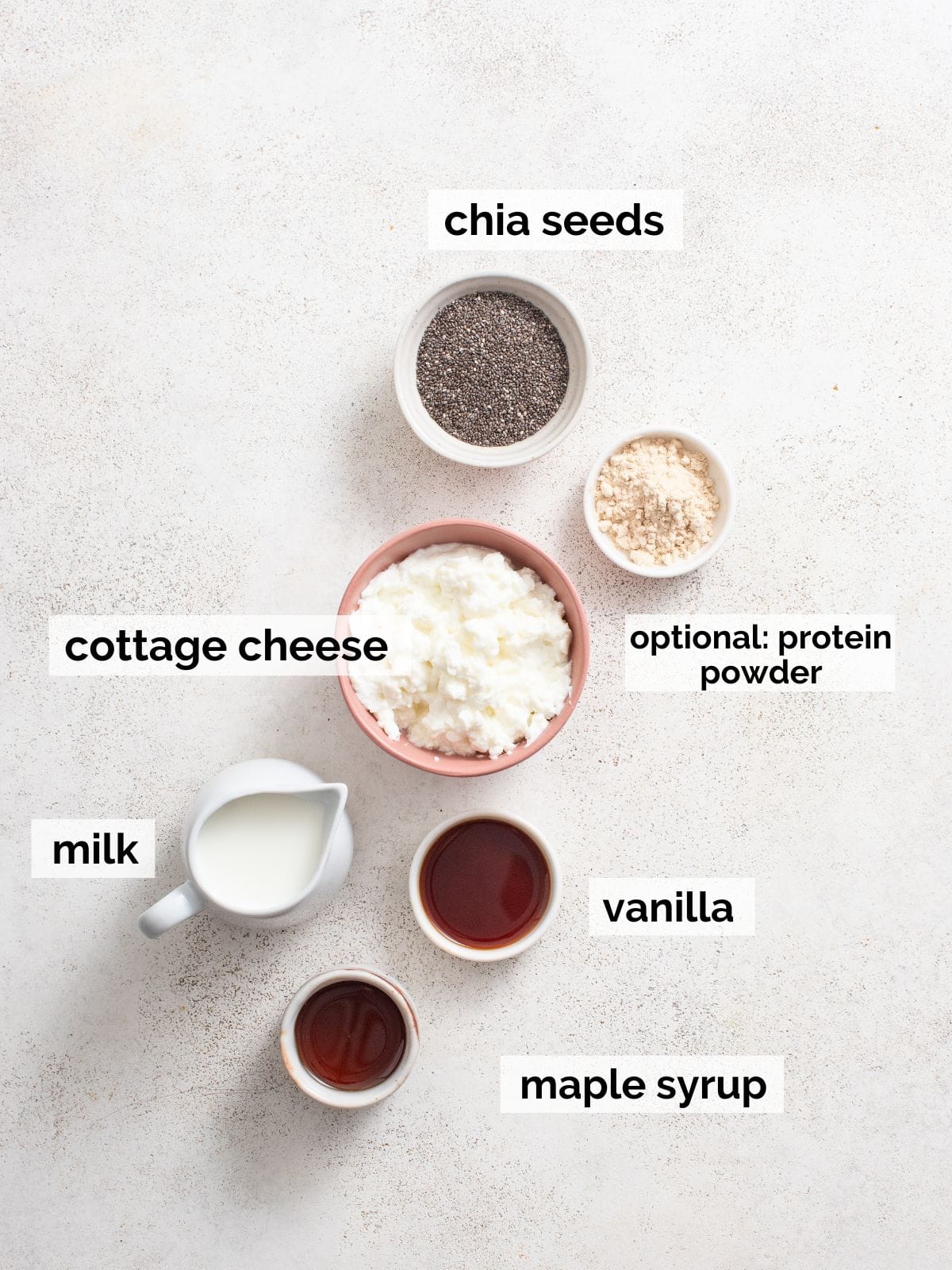 Ingredients for vanilla chia pudding on a white background.