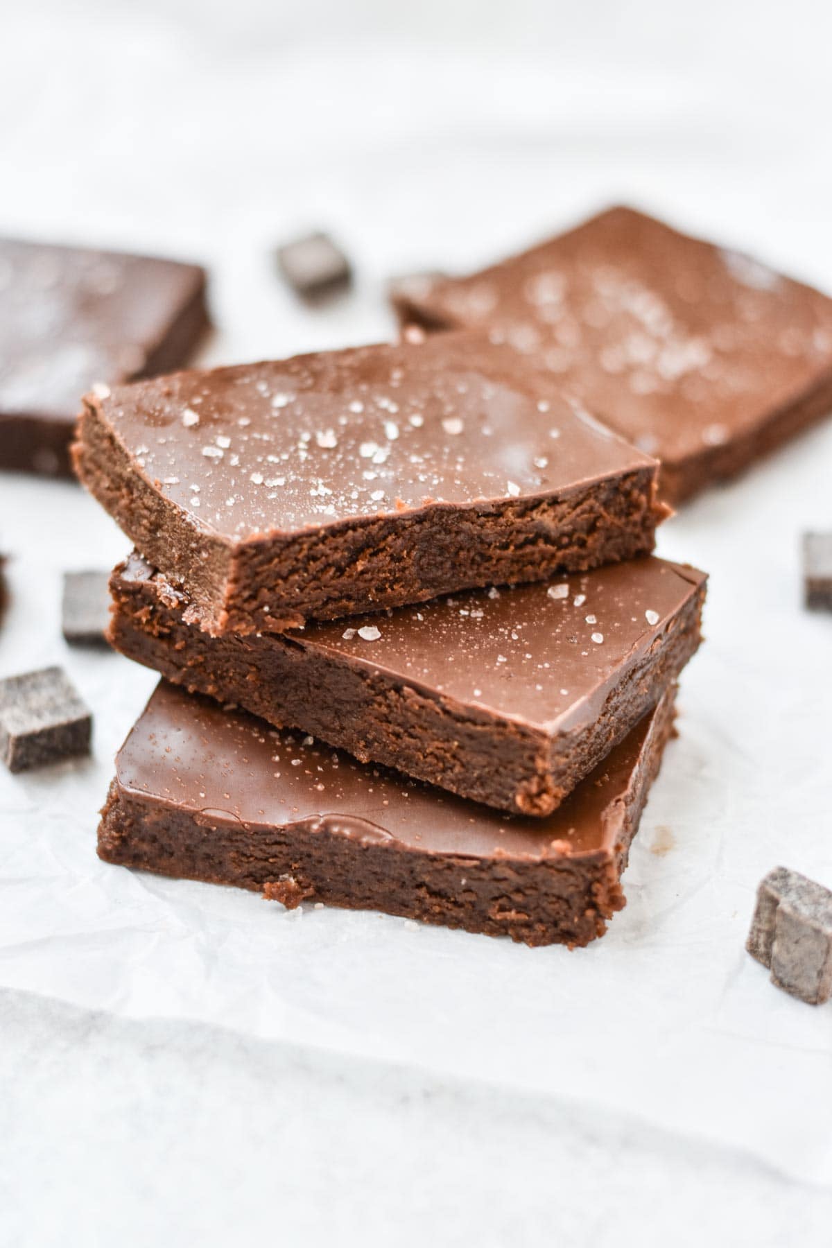 Brownies layered on top of each other with sea salt on top.