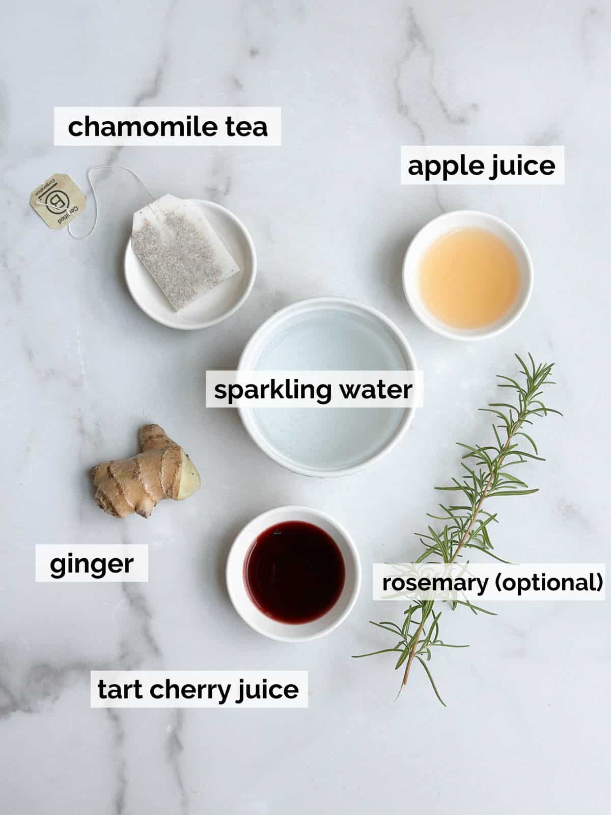 Ingredients for a sleepy girl mocktail on a marble table.