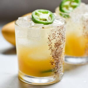 Non-alcoholic margaritas with a sumac salt rim on a marble background.