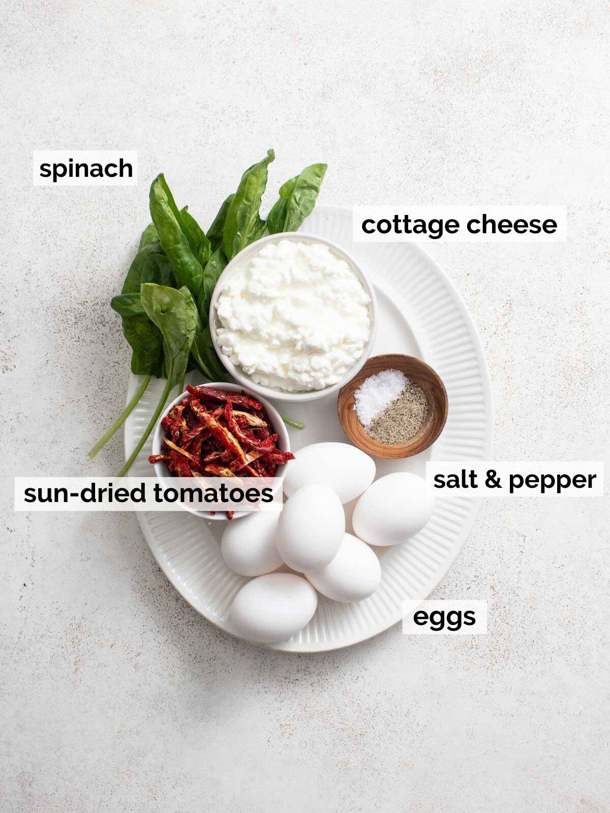 Ingredients for egg bites with cottage cheese and spinach on a white background.