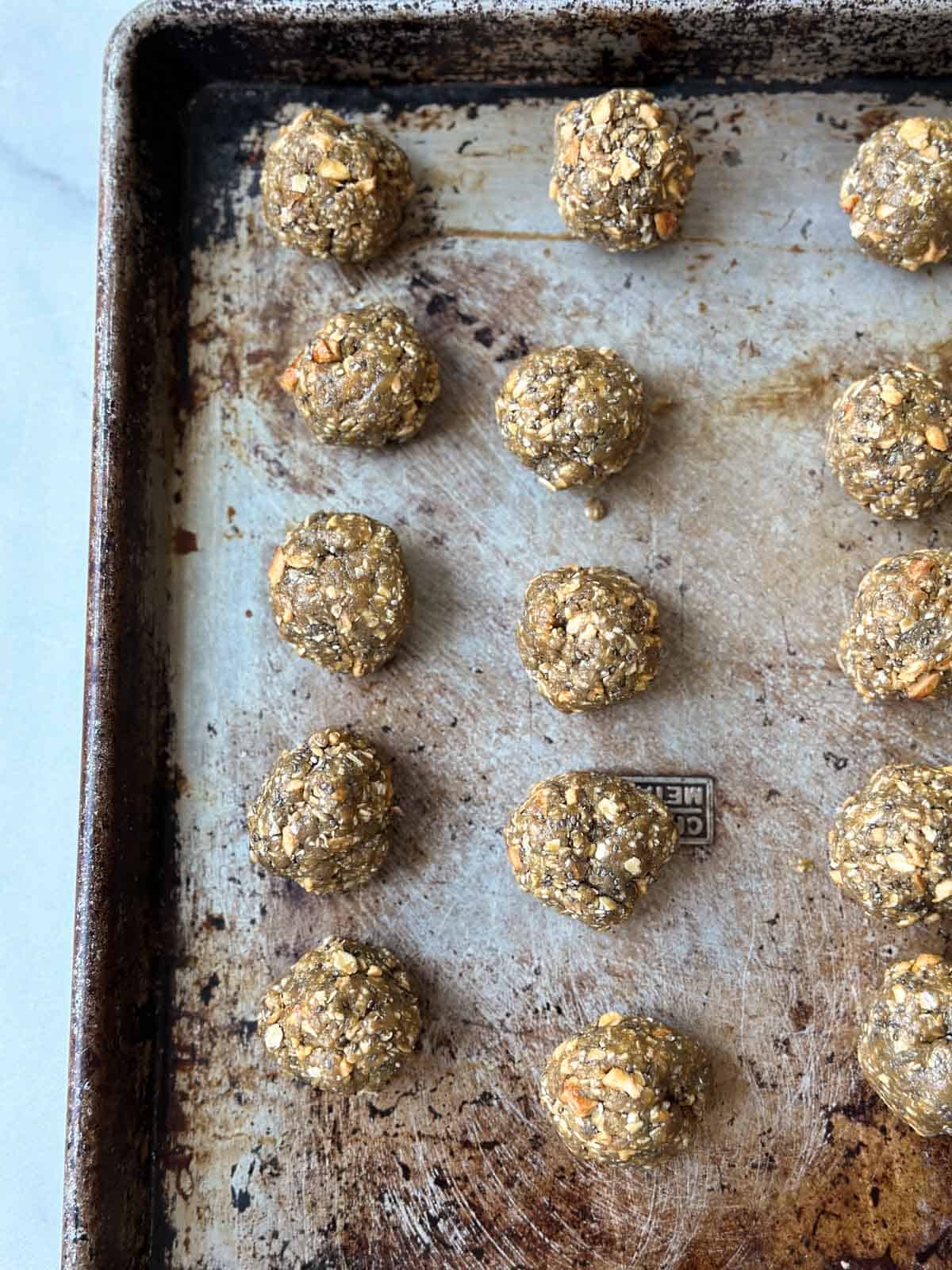 Energy oat balls all rolled onto a sheet pan. 