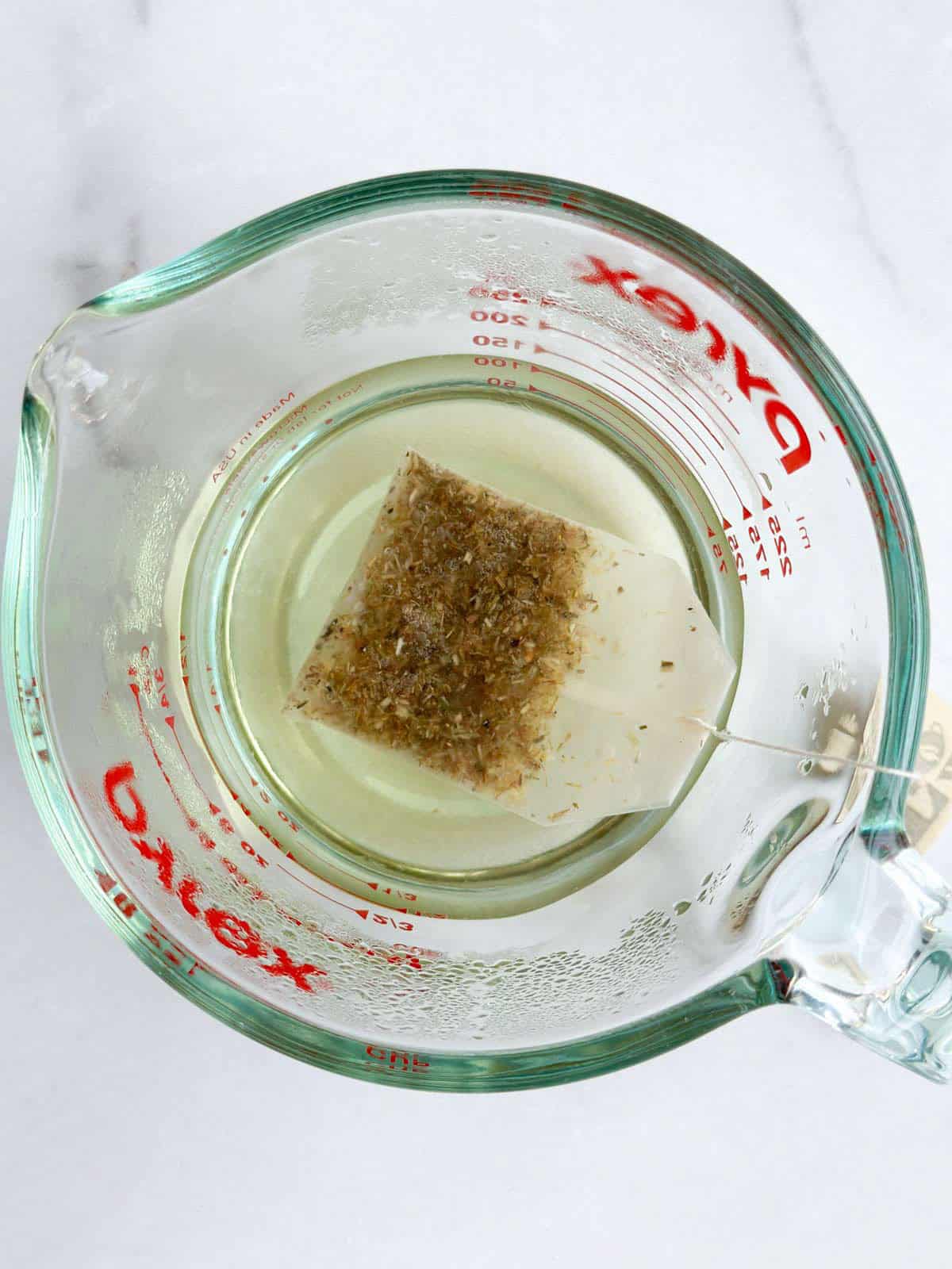 Chamomile tea being steeped in hot water.