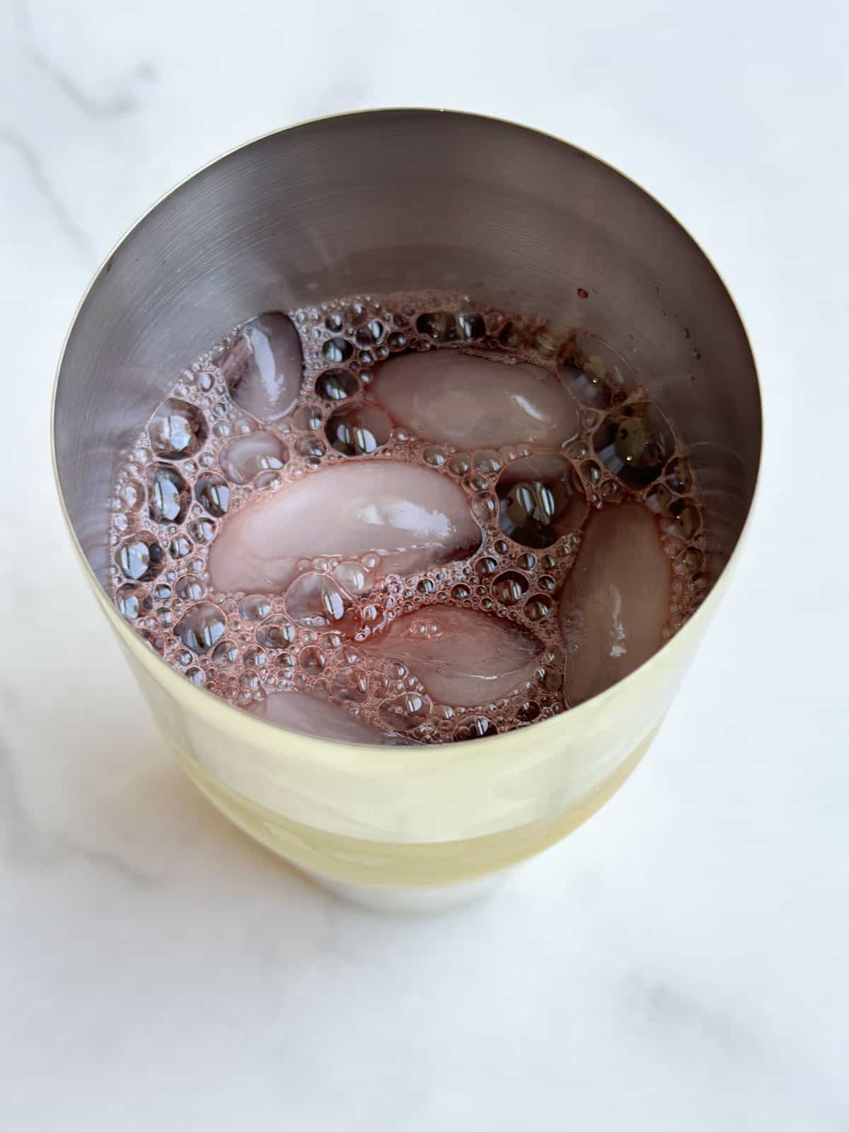 Tart cherry mocktail base in a cocktail shaker.