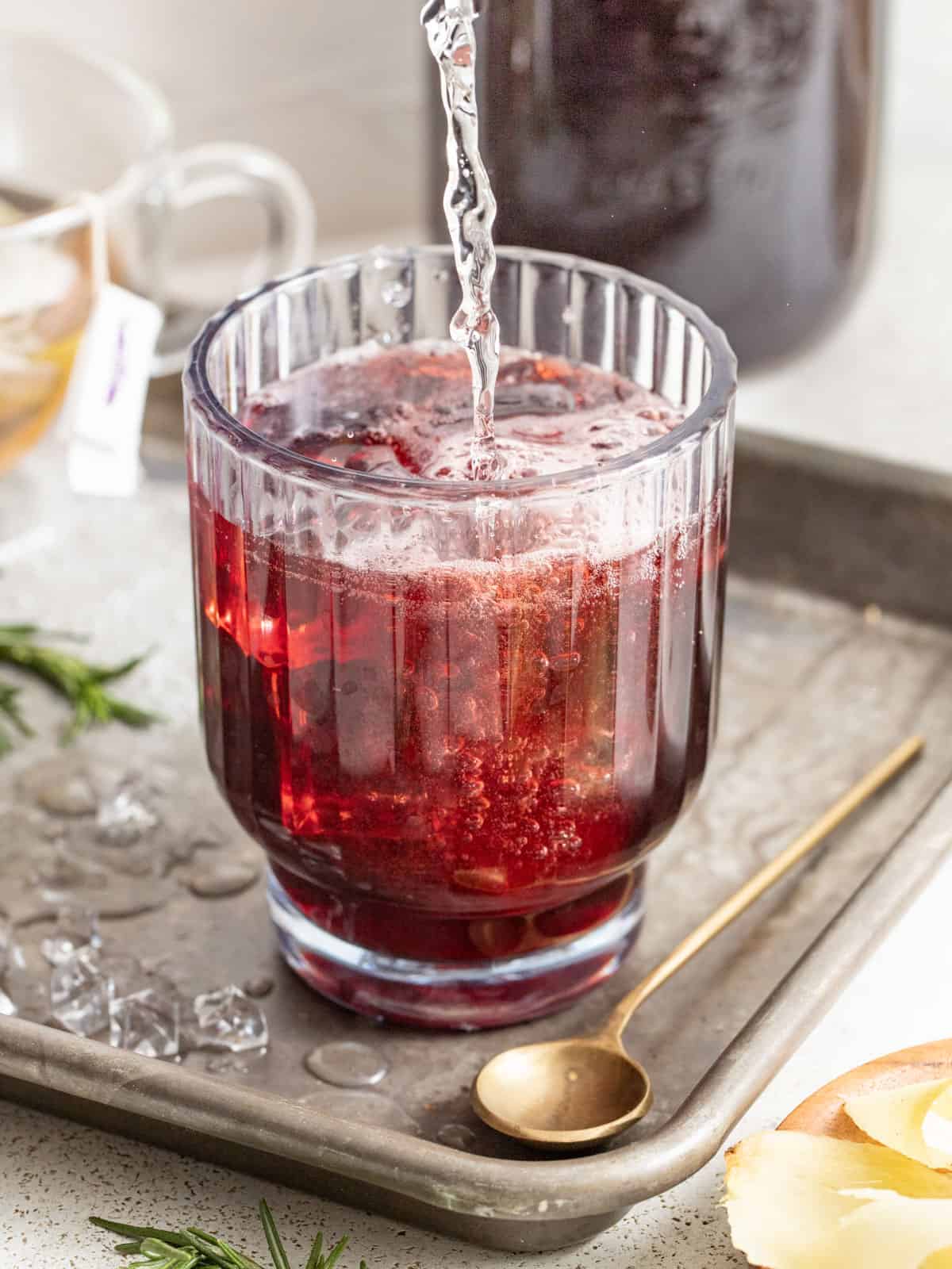 Pouring sparkling water into tart cherry juice.
