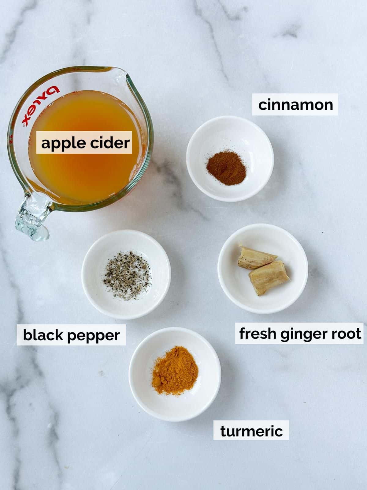 Apple cider and spices on a marble background. 