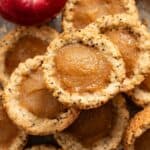 Apple pie bites stacked on top of each other.