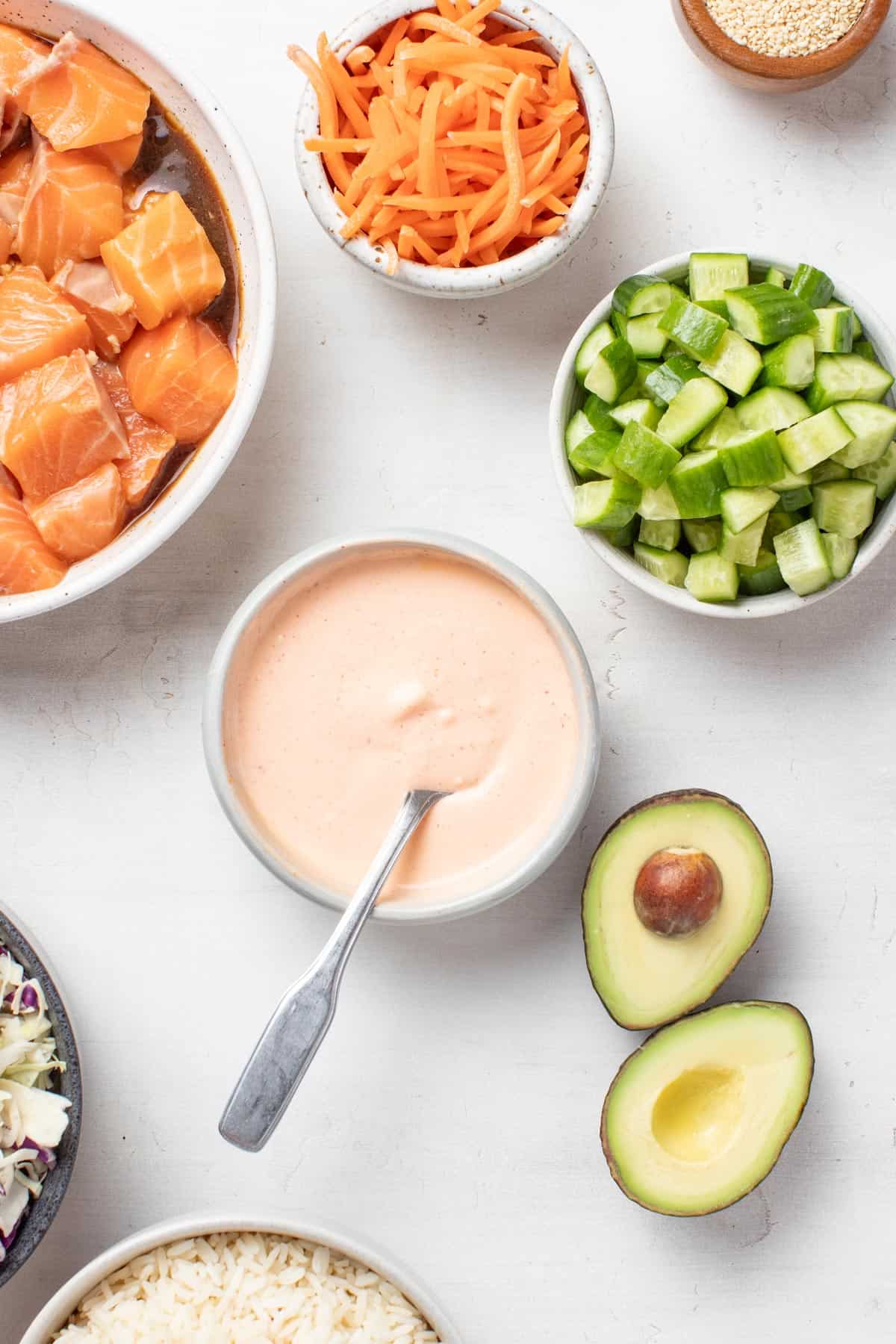 Spicy mayo with sriracha being stirred together in a small bowl.