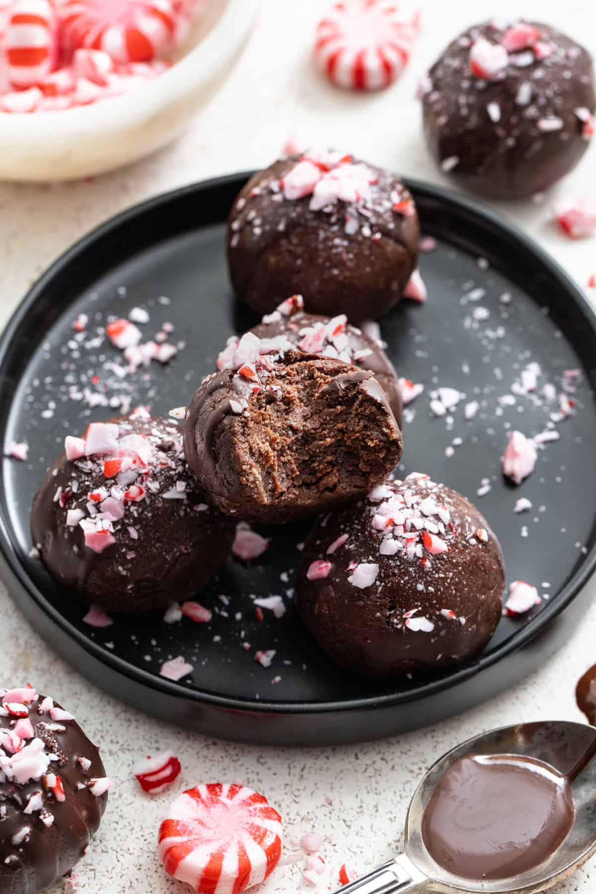A peppermint brownie ball with a bite out of it to show the gooey inside.