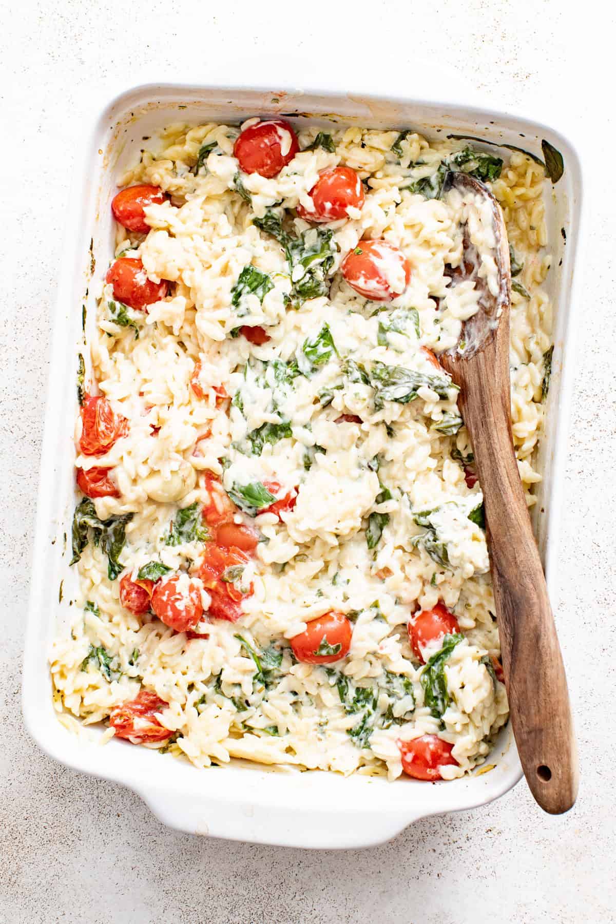 Boursin baked orzo after being baked and stirred with a spoon.