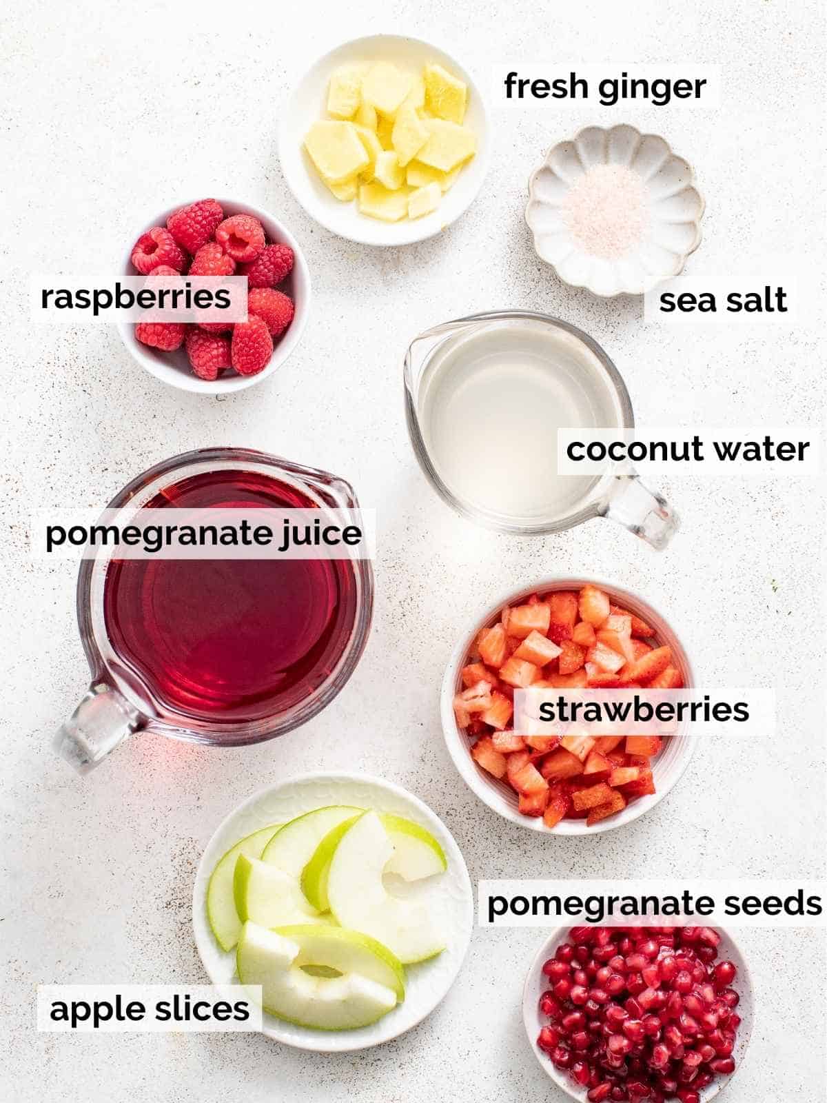 Ingredients for non-alcoholic sangria with pomegranate on a white background.