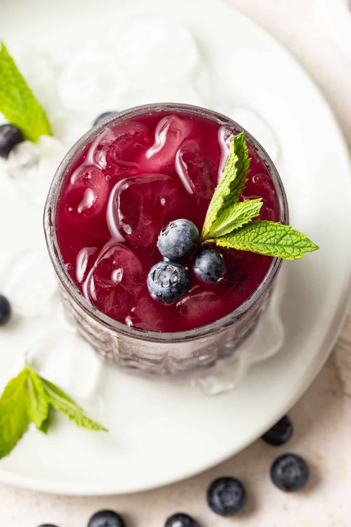 Top view of fresh blueberries and mint in a mocktail.