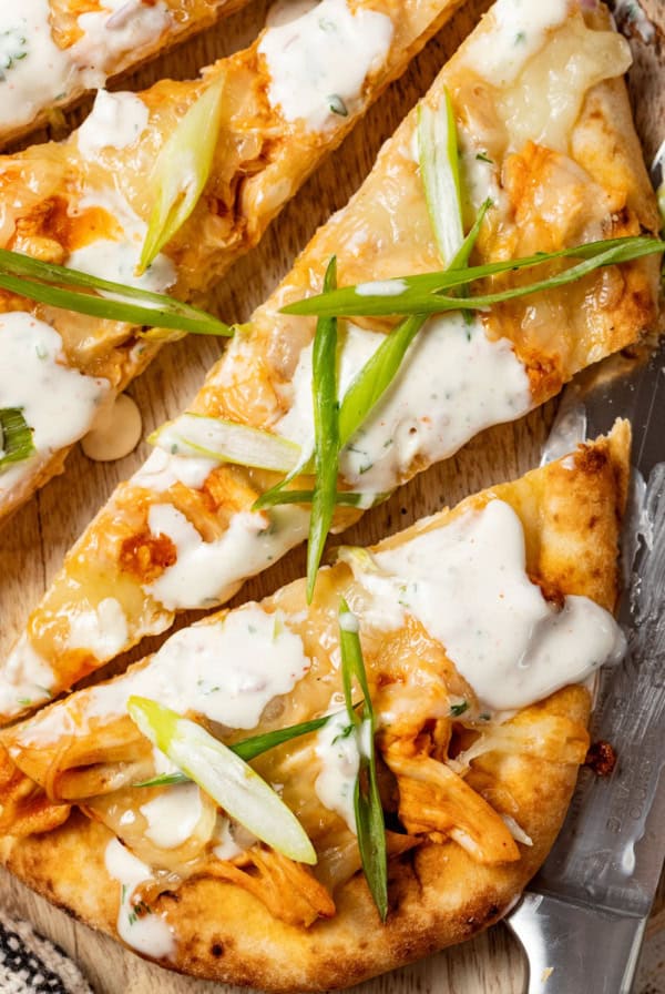 Buffalo chicken flatbread on a cutting board.