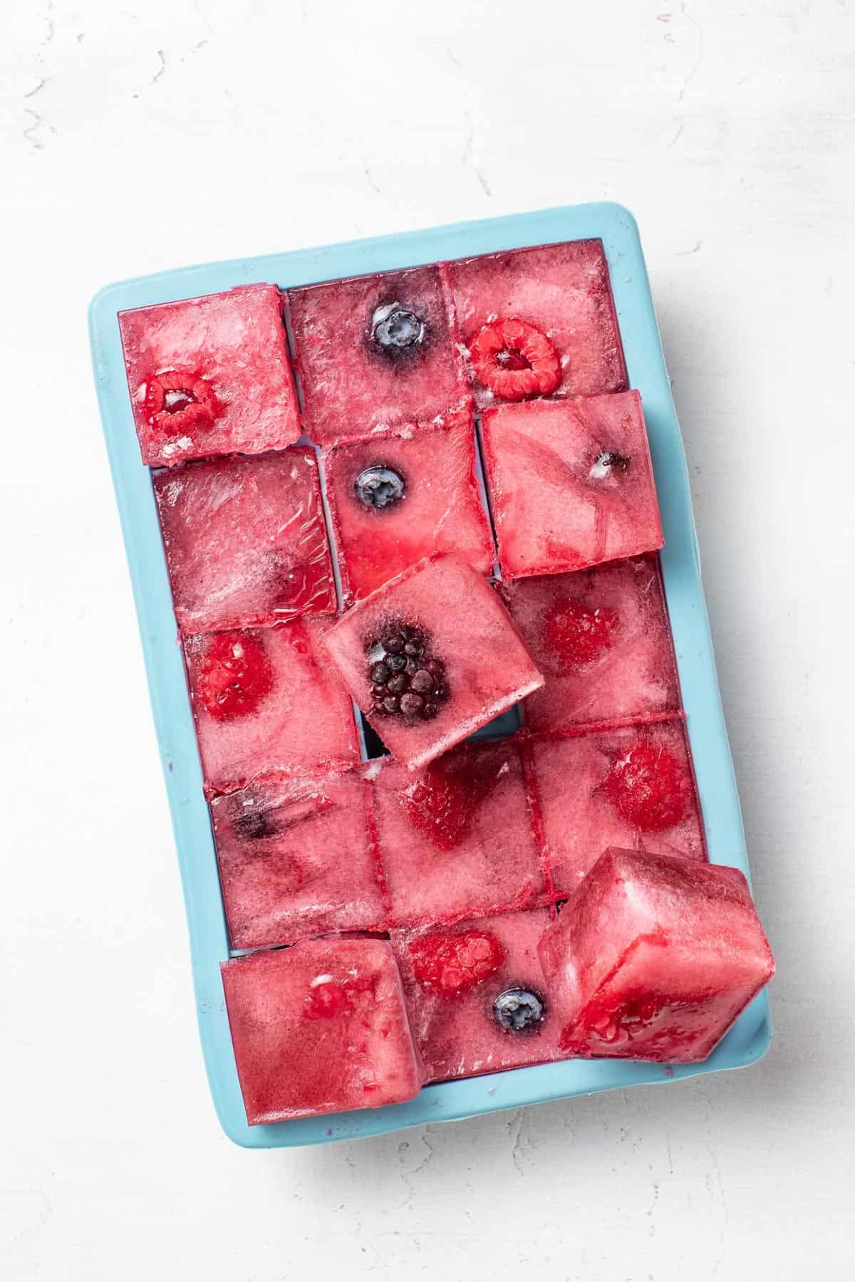 Berry gatorade ice cubes frozen into a silicone freezer cube mold.