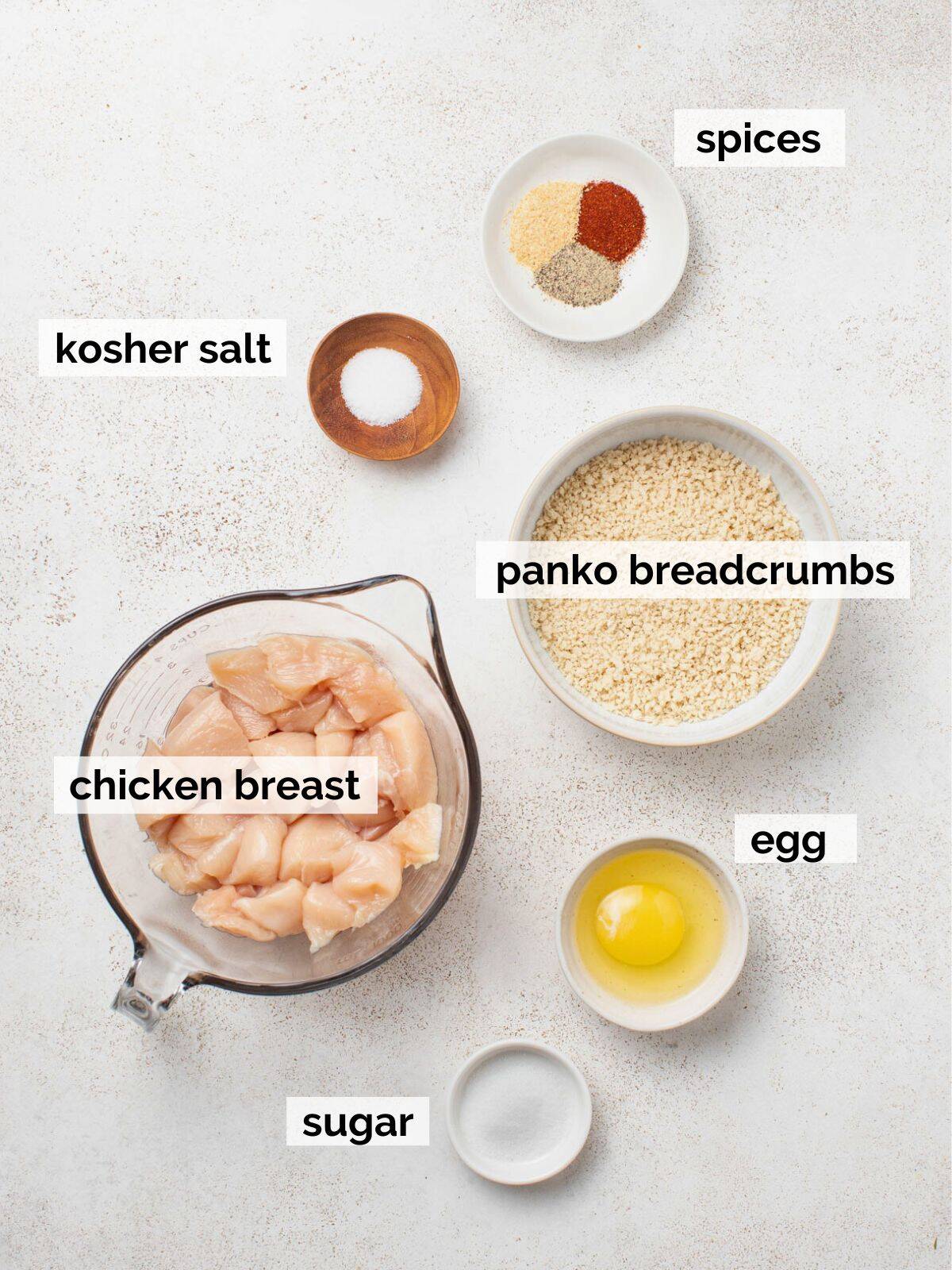 Ingredients for air fryer chicken nuggets on a white background.
