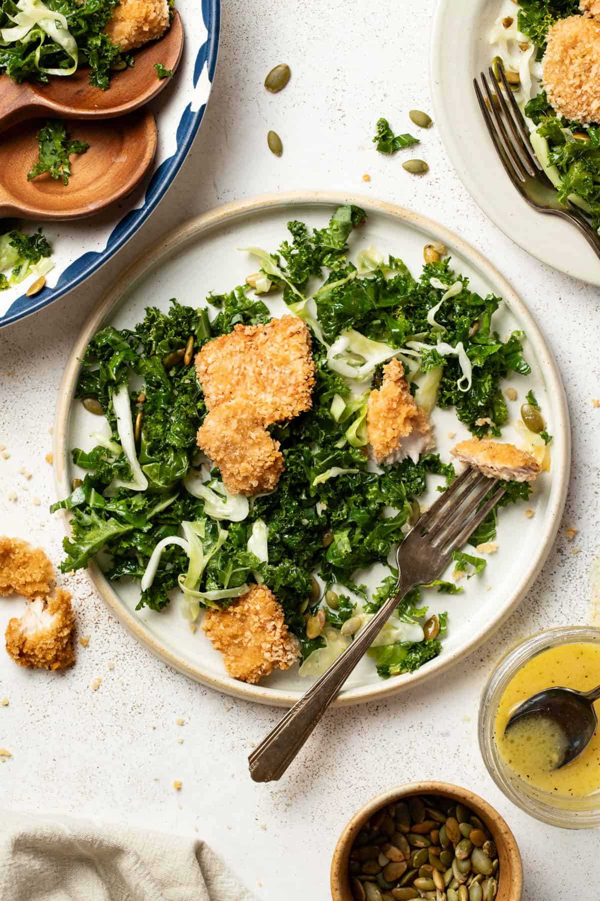Air fryer chicken nuggets on top of a kale crunch salad.