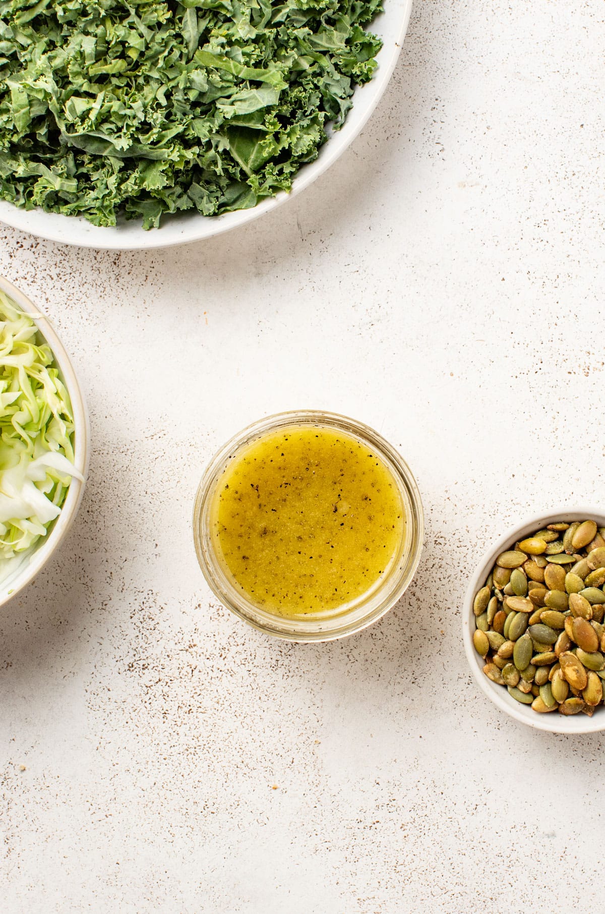 Mixing together an apple cider vinaigrette in a mason jar.