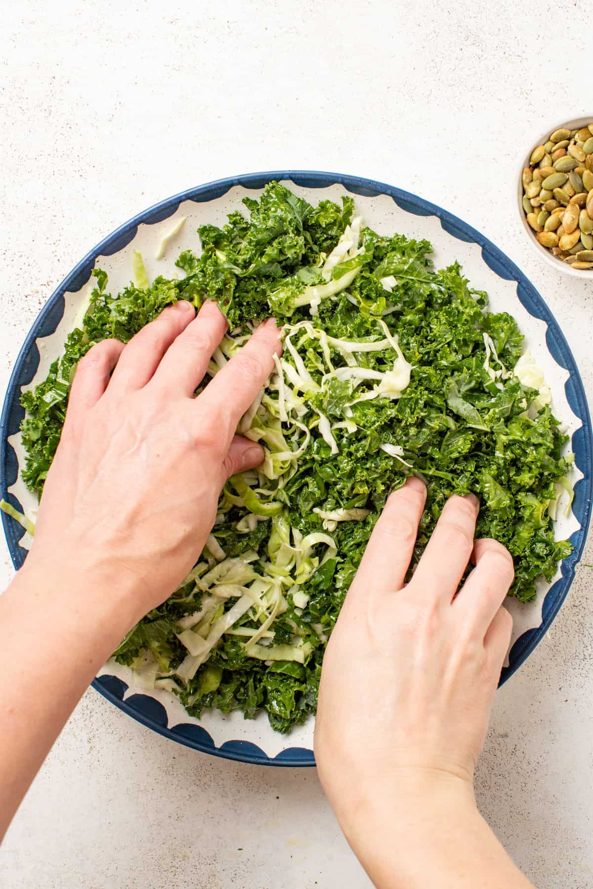 Massaging the kale leaves with hands.