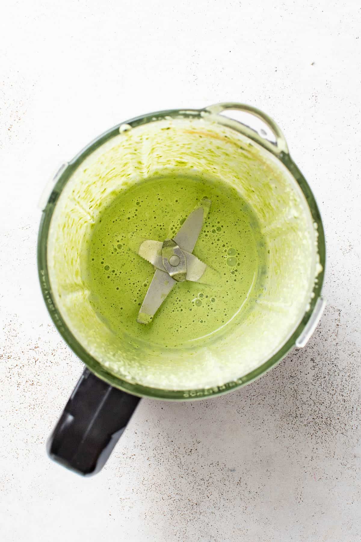 A creamy dressing blended in a food processor with herbs and hemp seeds.