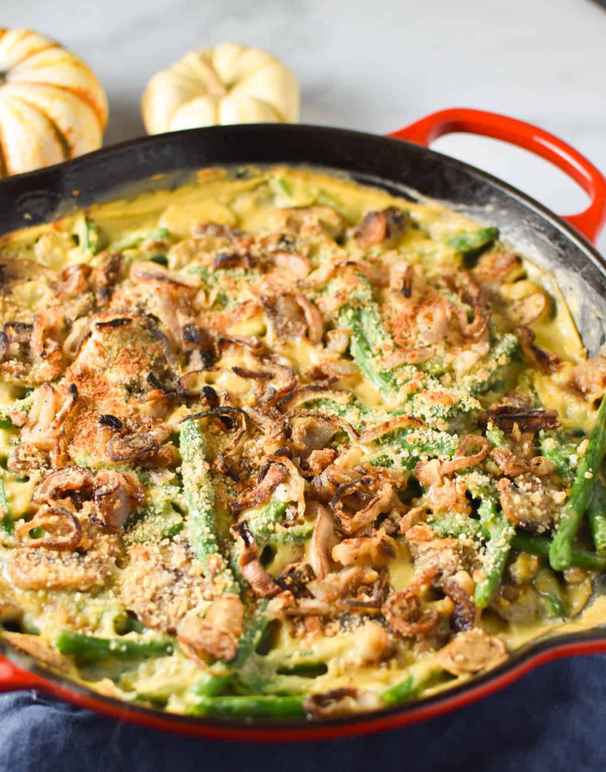 A green bean casserole with fresh green beans and crispy panko on top.