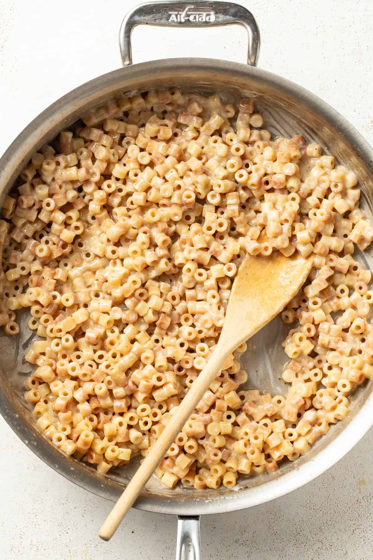 Butter pasta in a stainless pan after the butter is whisked in.