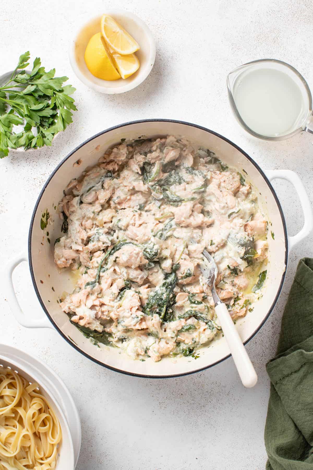 Stirring the Boursin cheese, spinach, and salmon together after cooking.