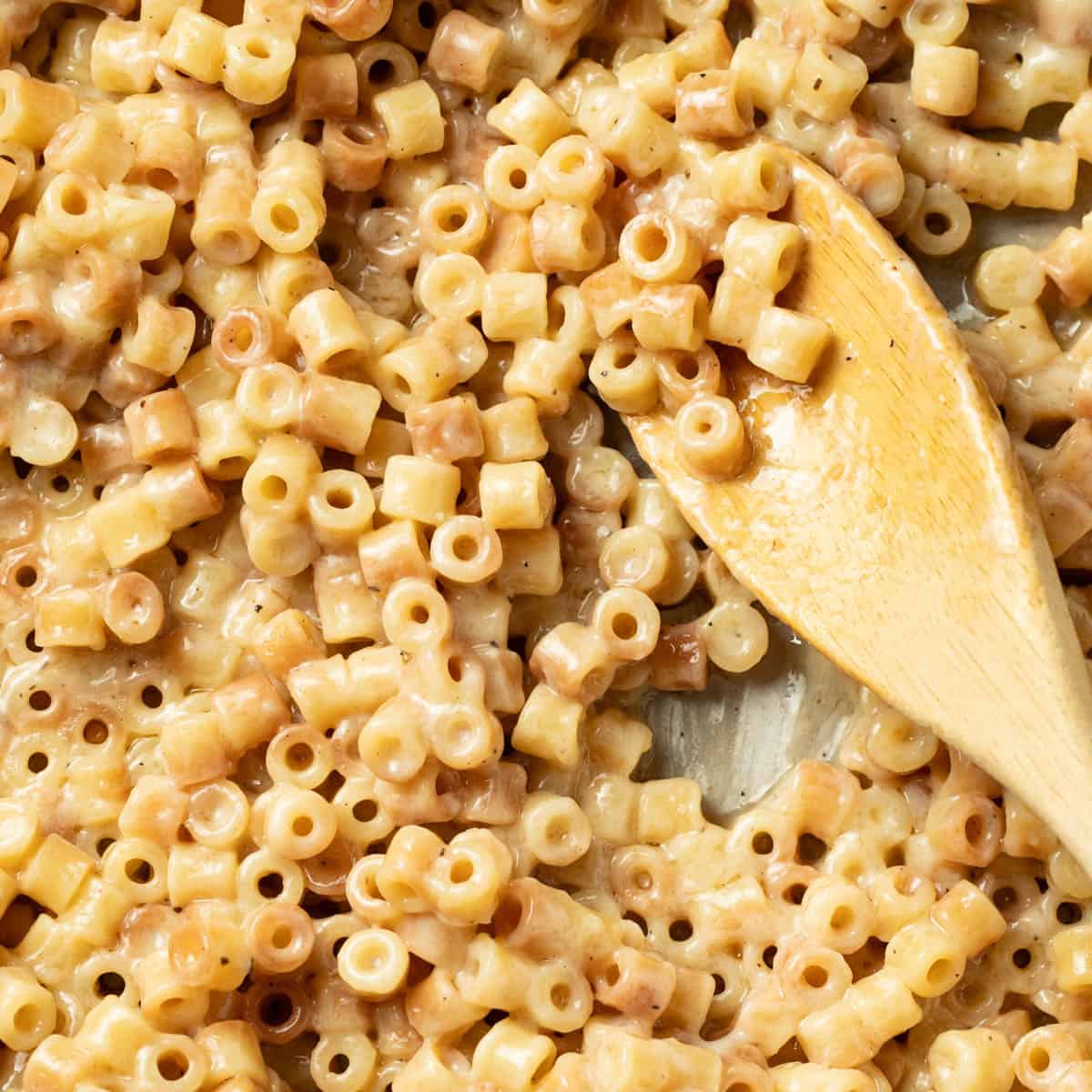 Butter pasta on a wood spoon.