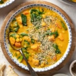 Turmeric chickpea stew in a bowl topped with hemp seeds.