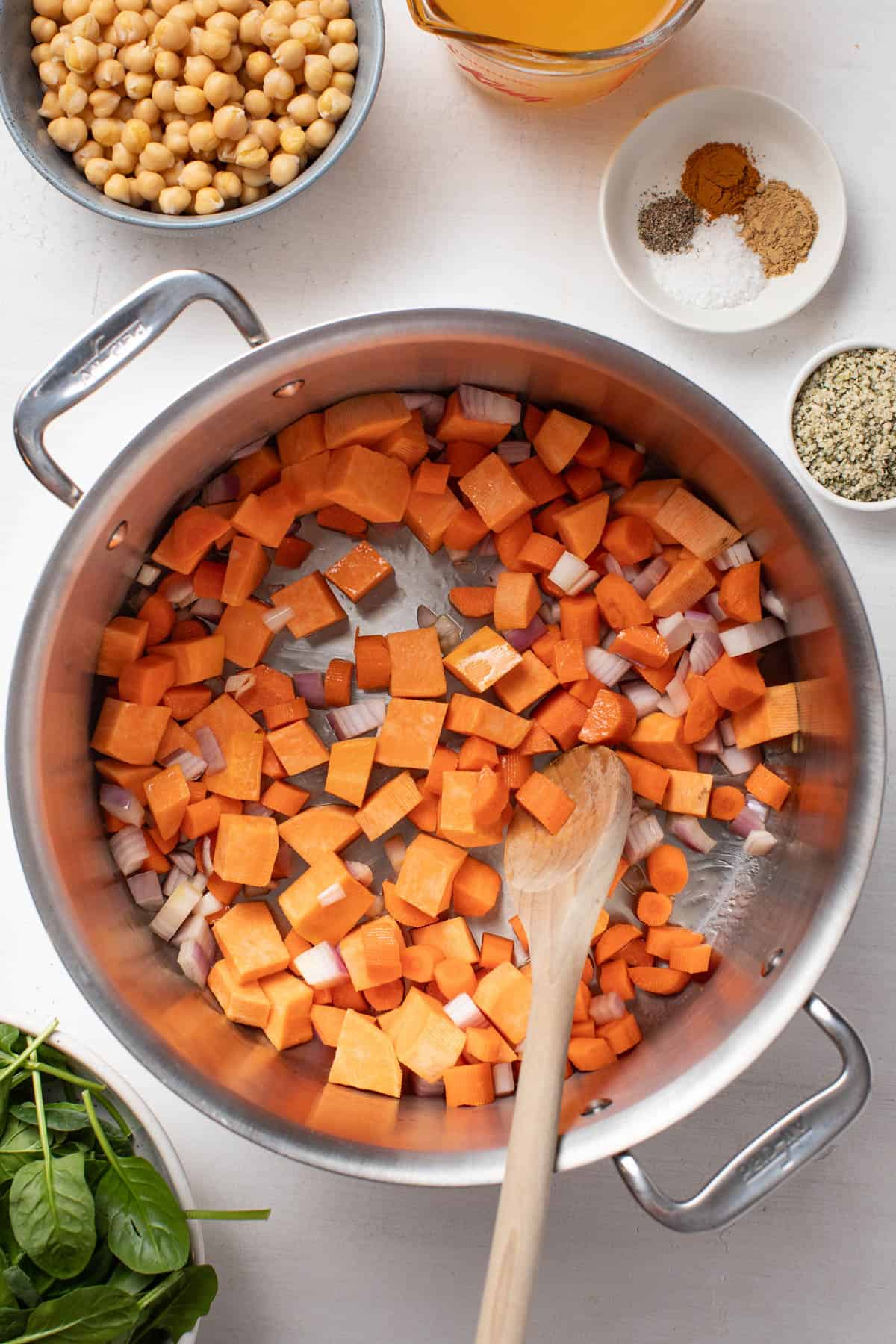 Cooking the carrots, sweet potatoes and shallots in a large pot.