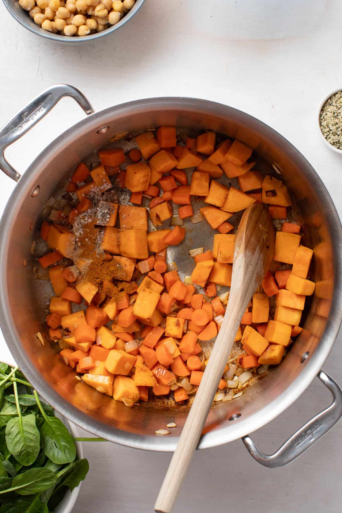 Adding ginger and turmeric to the sweet potatoes.