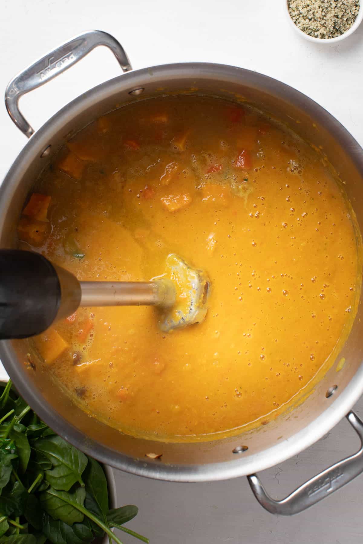 Blending the sweet potatoes and chickpeas into a smooth soup.
