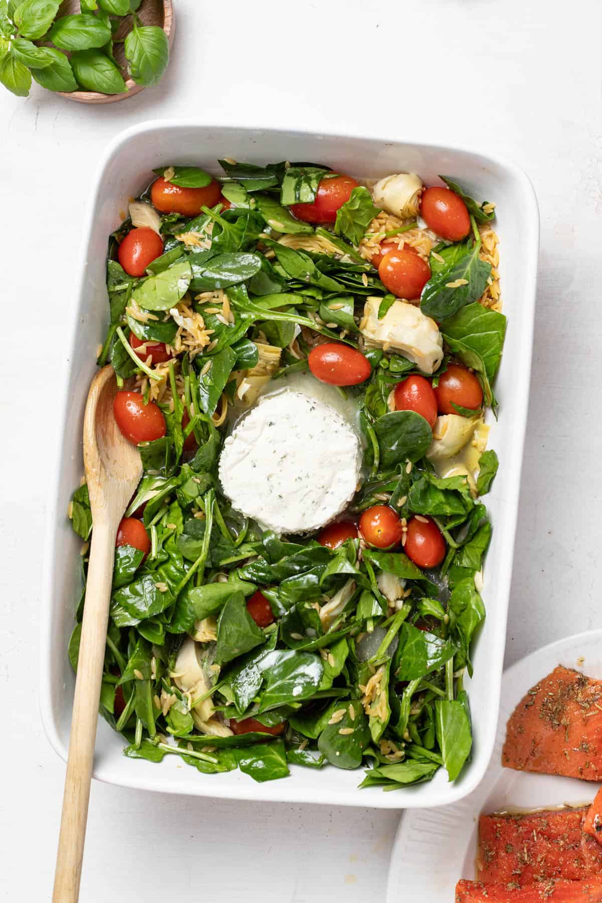 Adding the Boursin cheese to the center of the baking dish.