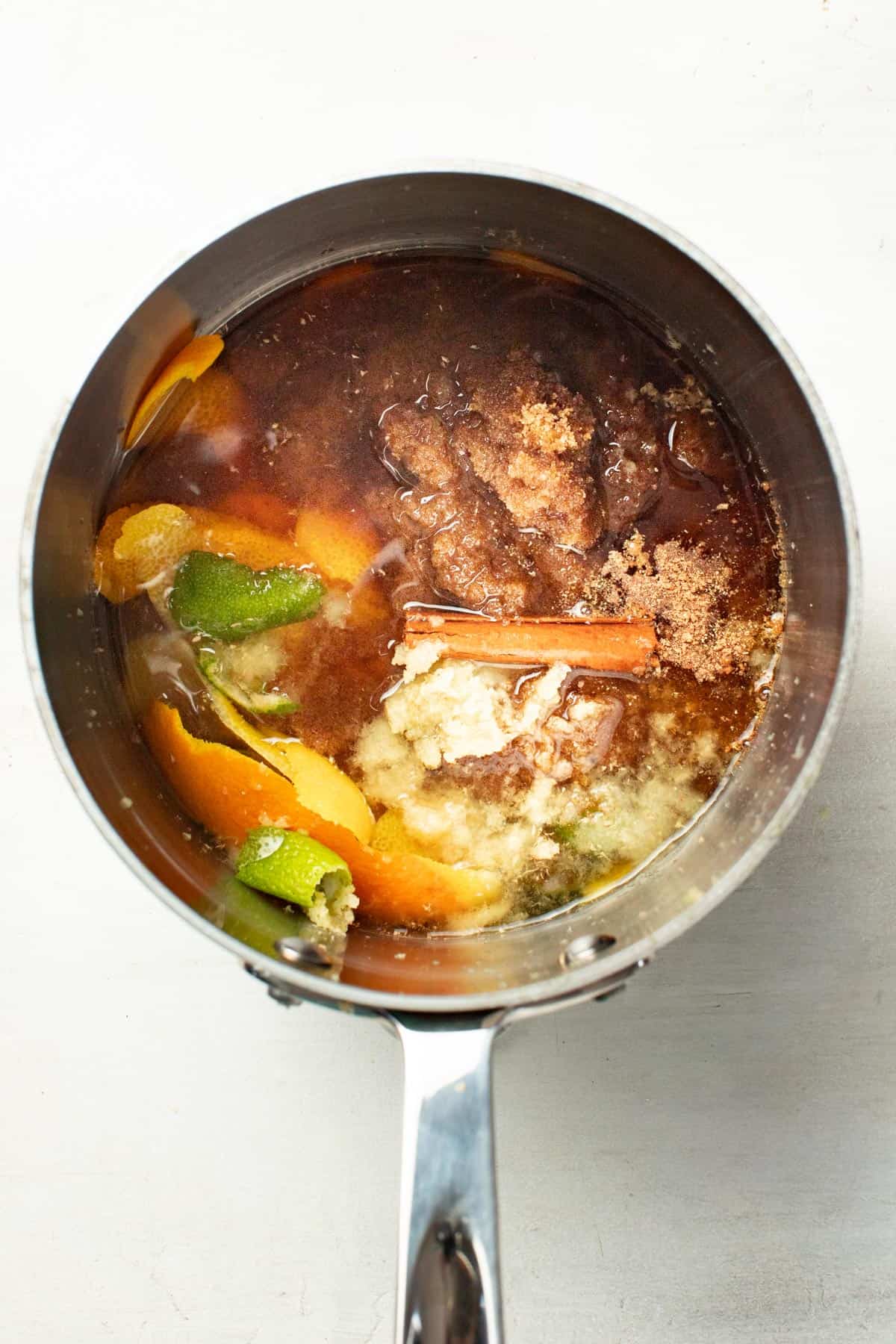 Adding all the ingredients to a small pot with water.