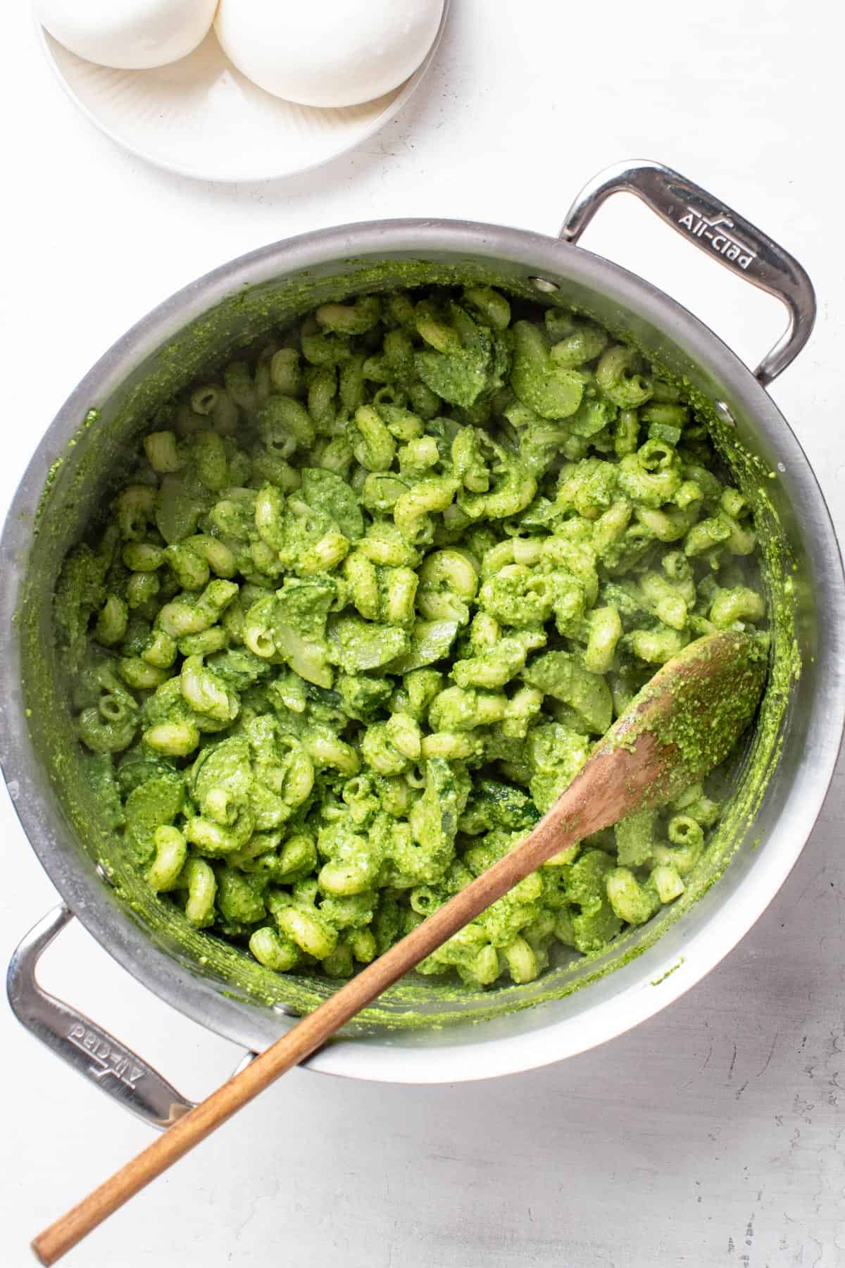 Mixing the homemade spinach pesto into the pot with the pasta.