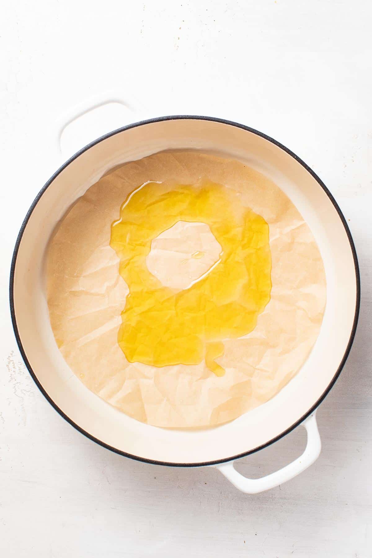 Oil on top of parchment paper in a pan.