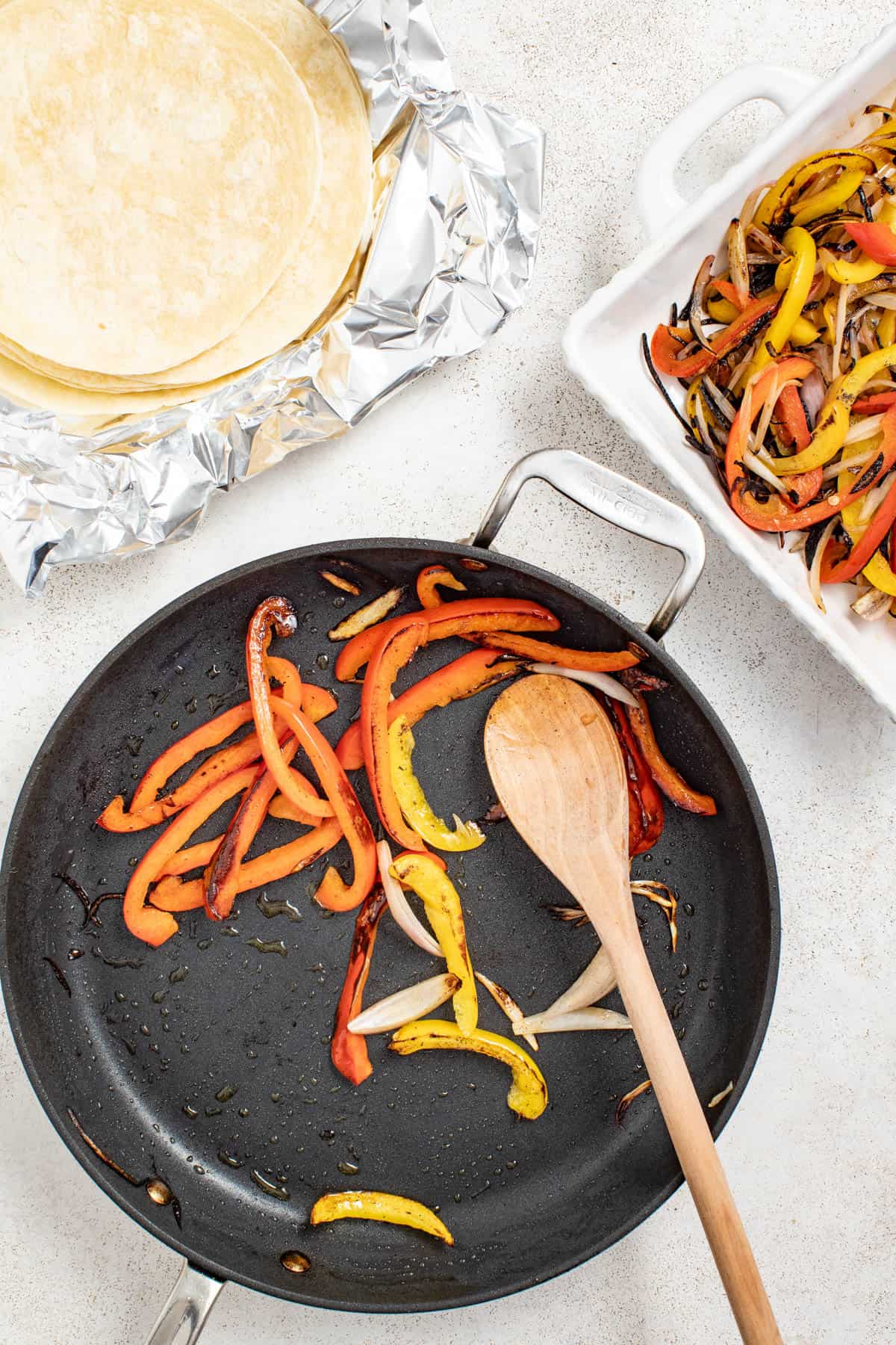 Seared peppers and onions after cooking in a cast iron pan.