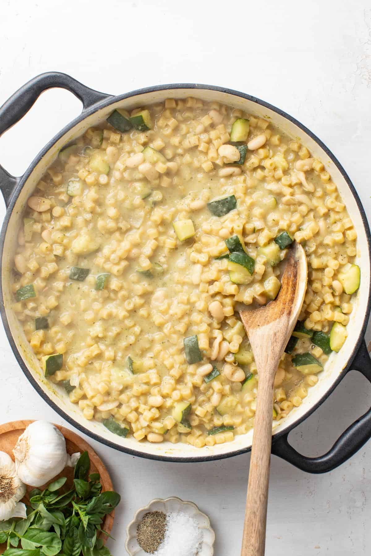 Stirring the blended zucchini sauce into the ditalini pasta.