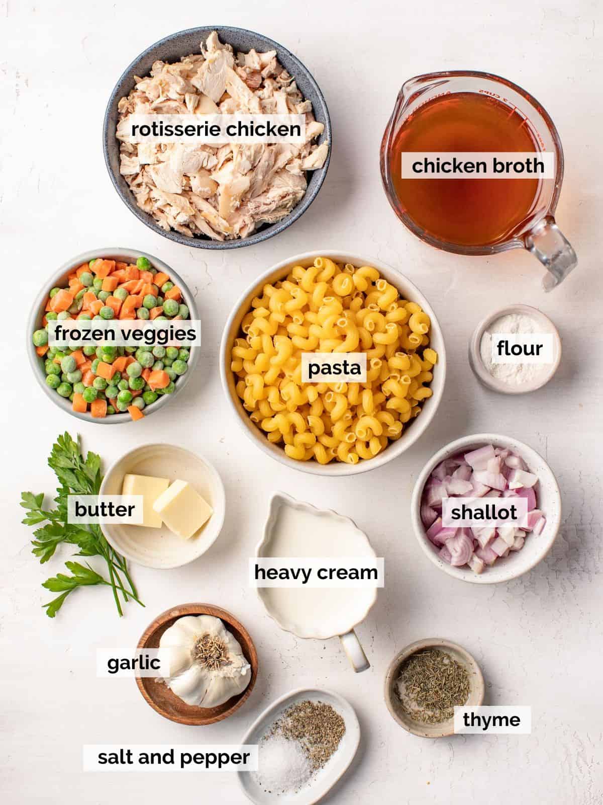 Ingredients for chicken pot pie pasta on a white background.