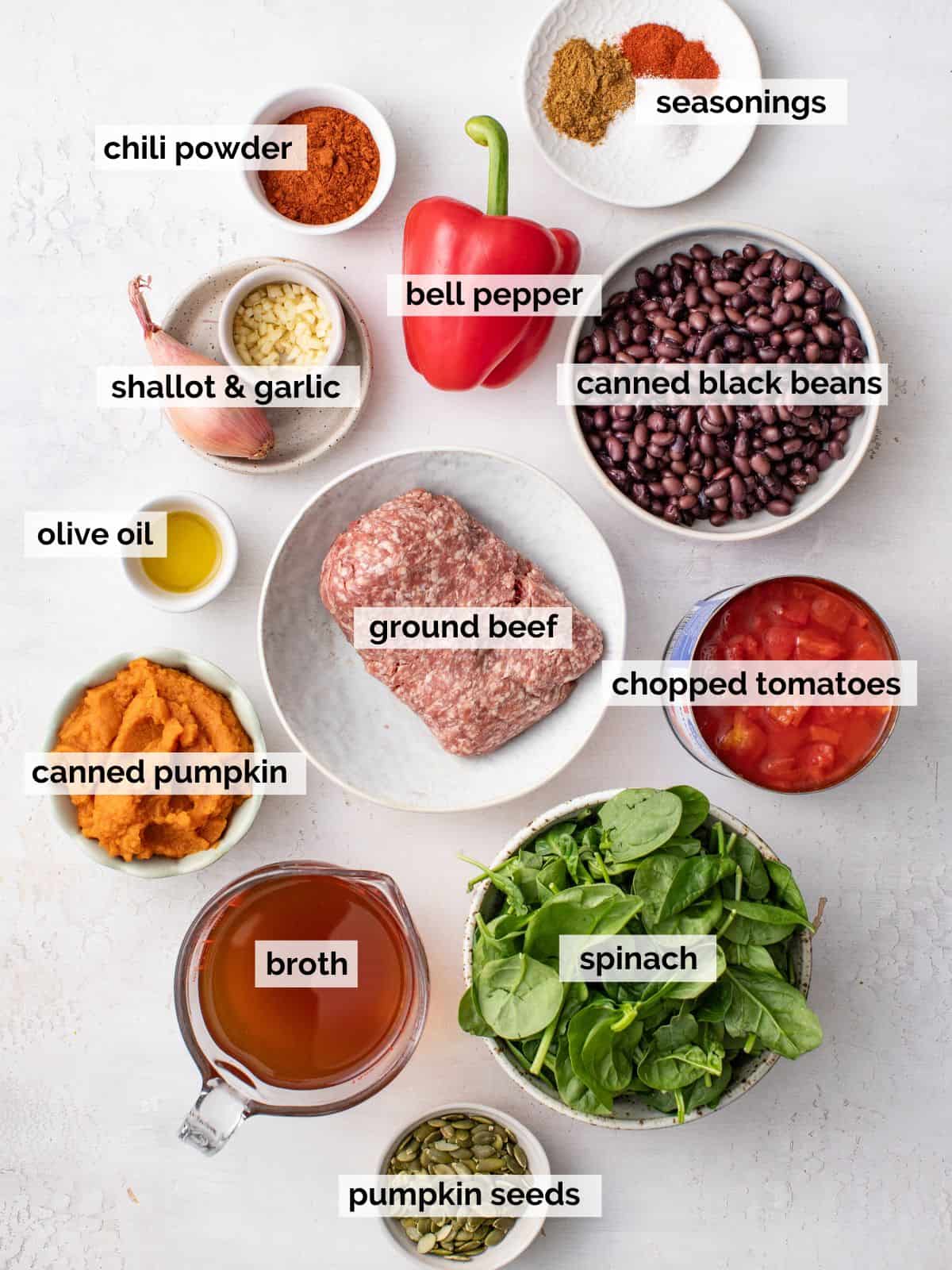 Ingredients for pumpkin chili on a white background.