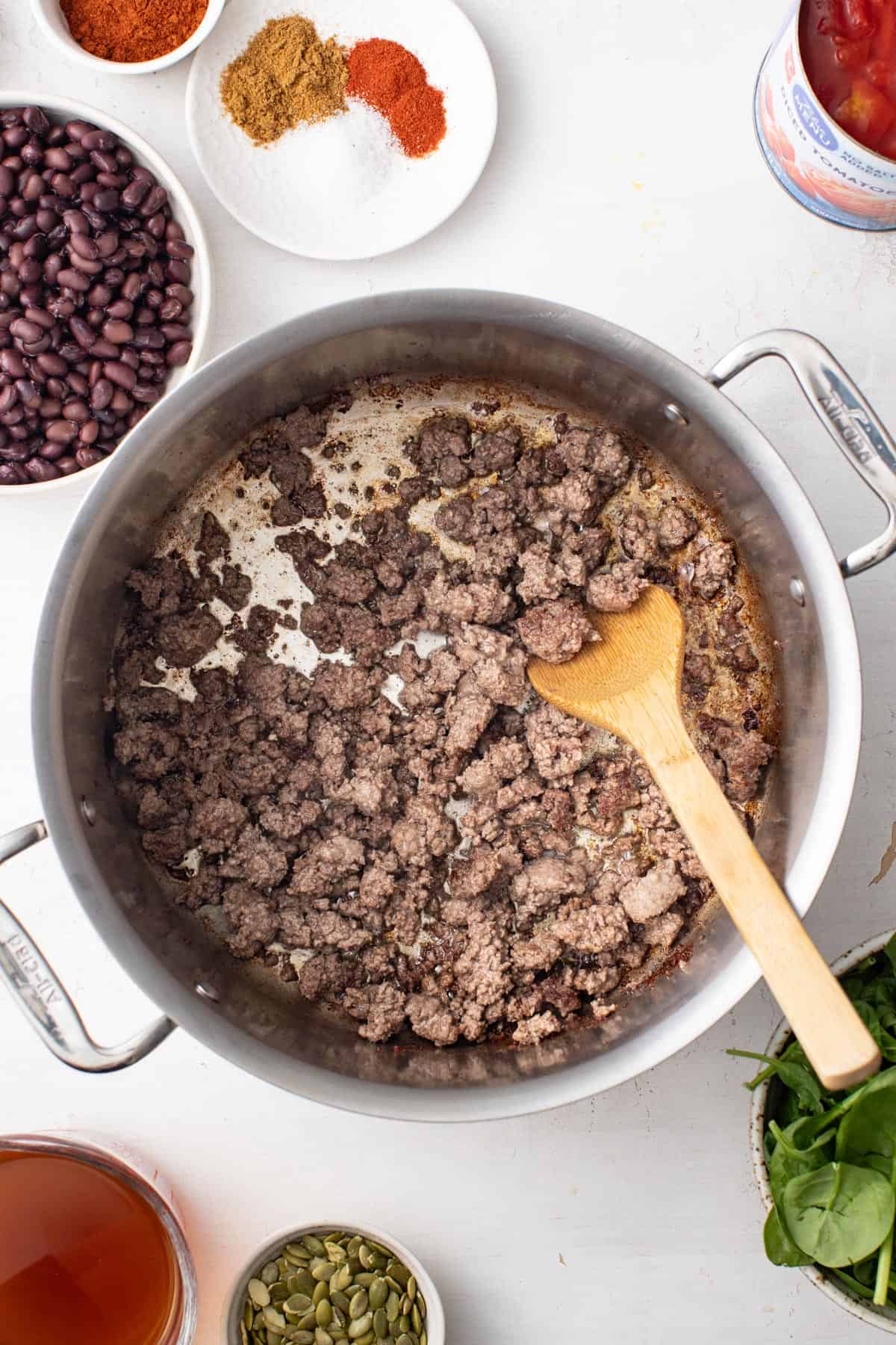 Browning ground beef in a soup pot.